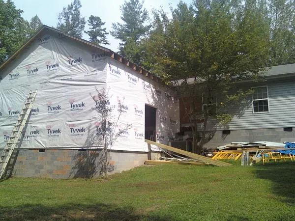 Tyvek wrapped gable on a new room addition beside an existing home in Michigantown